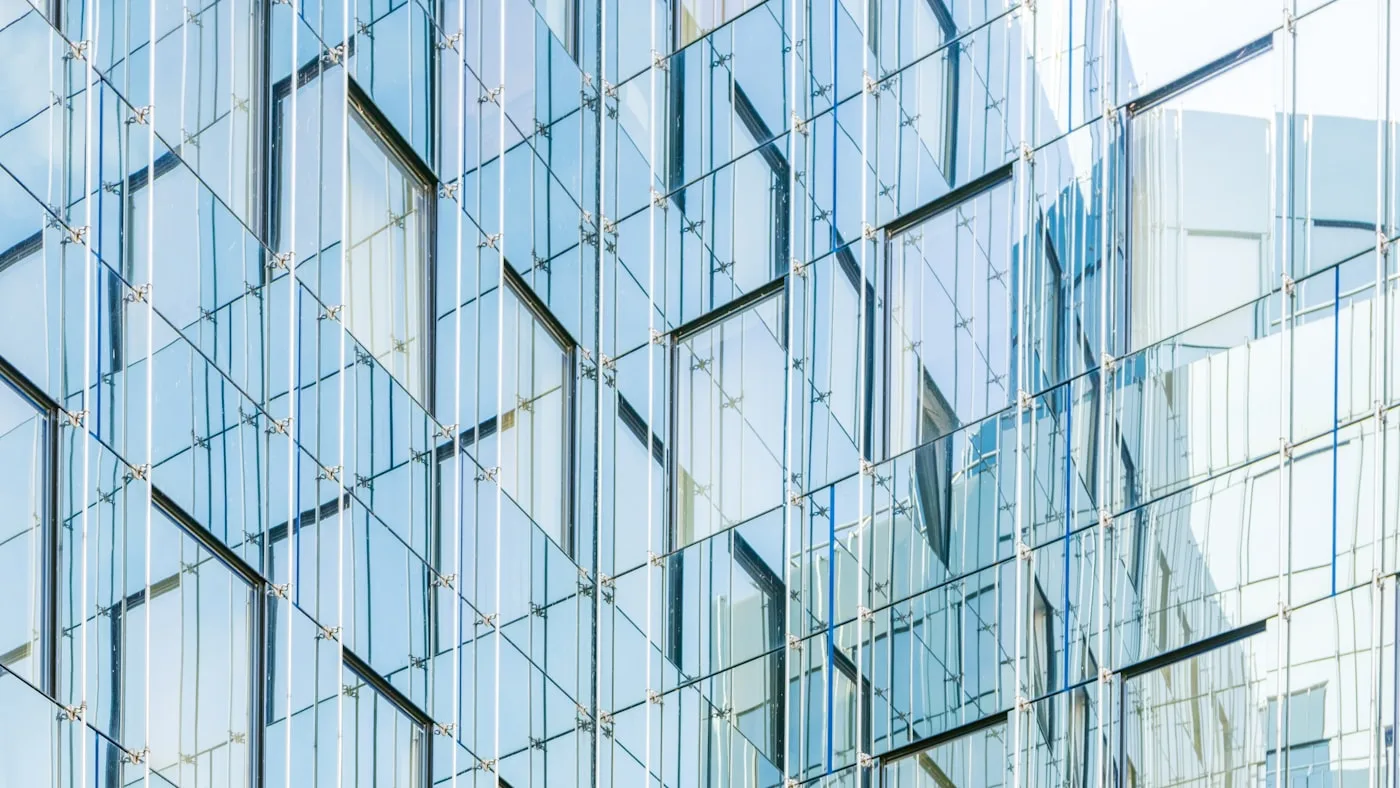 A glass office facade reflecting daylight